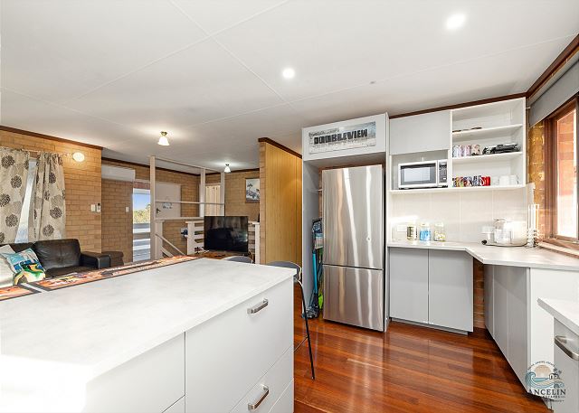Kitchen island with fridge and microwave