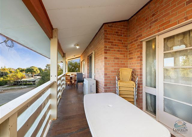 Front balcony with dining area and views